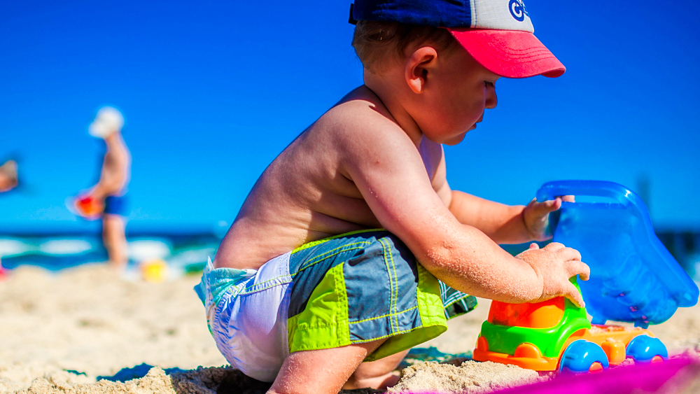 image of boy playing in sand